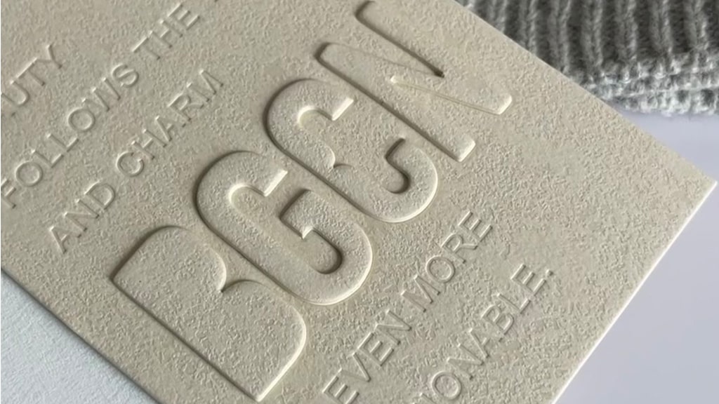 a clothing hang tag showing the effects of embossing vs debossing.