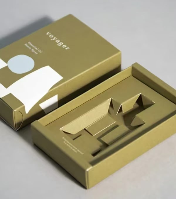 a green folding carton with paperboard insert inside