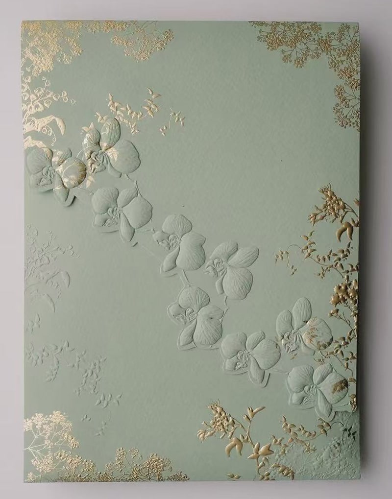 a green gift box with multi level sculptured embossing