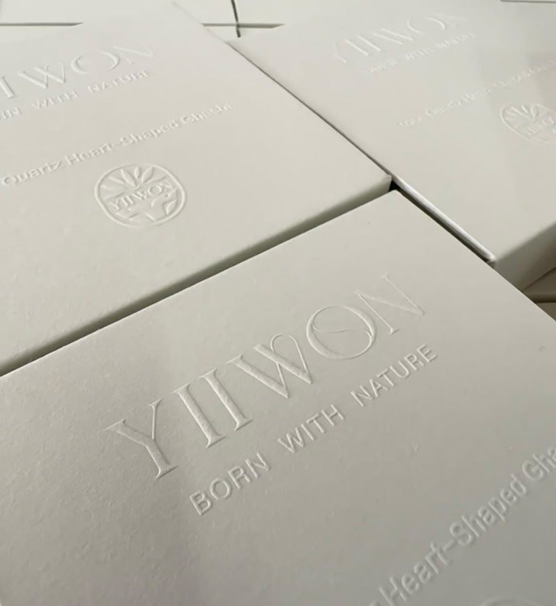 a white gift box with embossing finish on logo