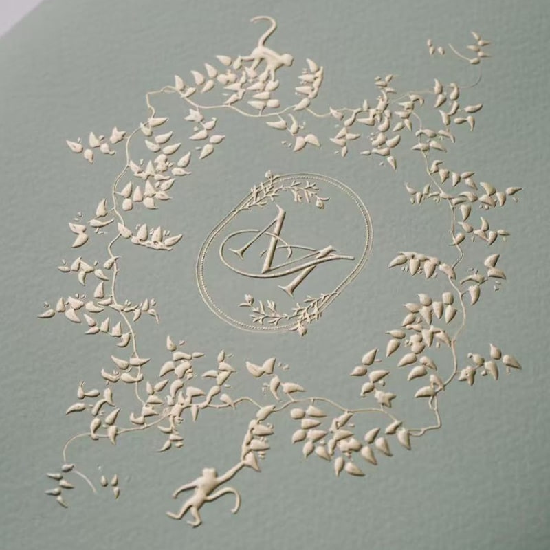 combo embossing finish on a m letter surrounding by flowers