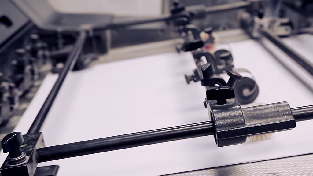 Paper sheets feeding into an offset printing machine during the printing process